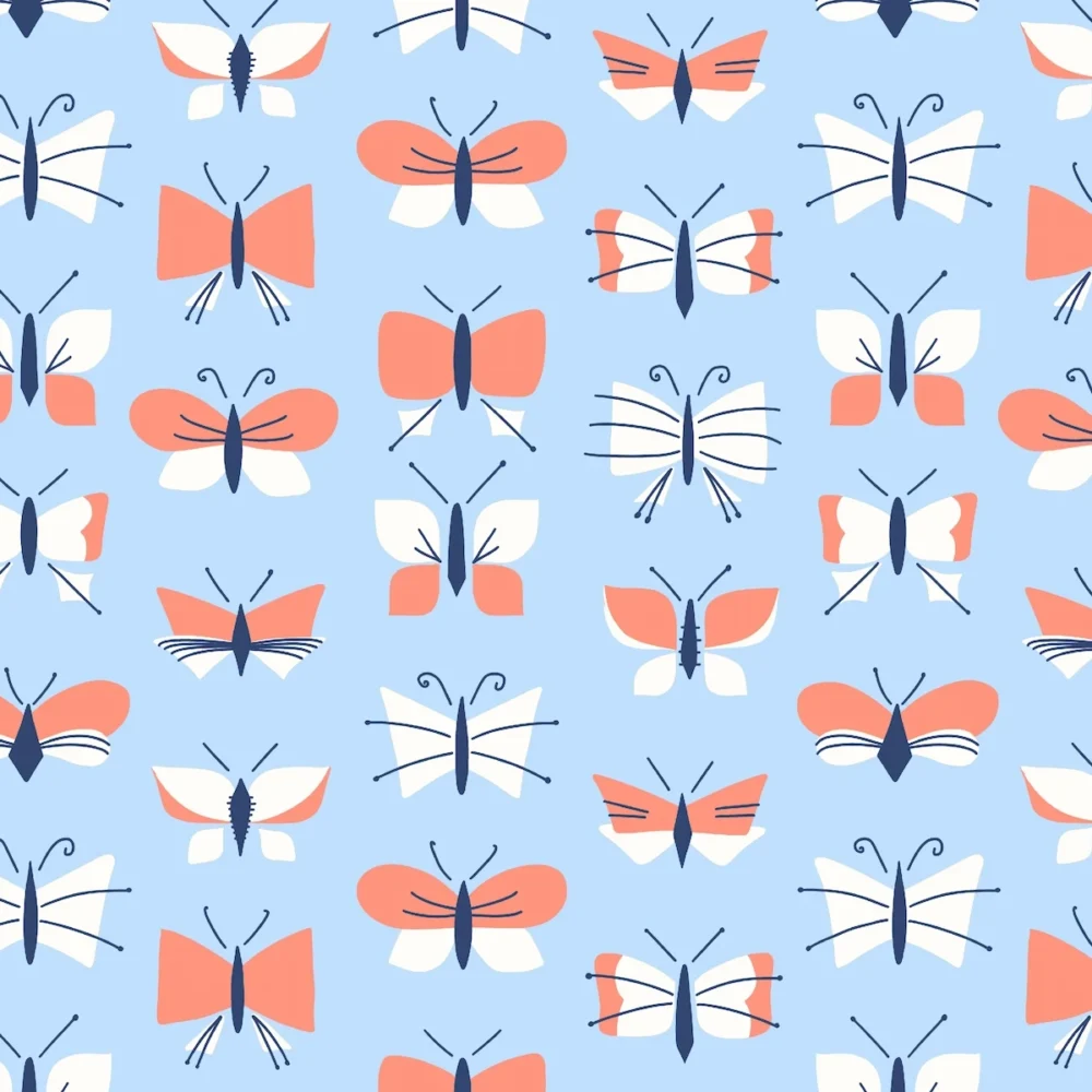 Playful butterfly pattern with varied sizes and shapes in light blue and pink for children's apparel hero piece
